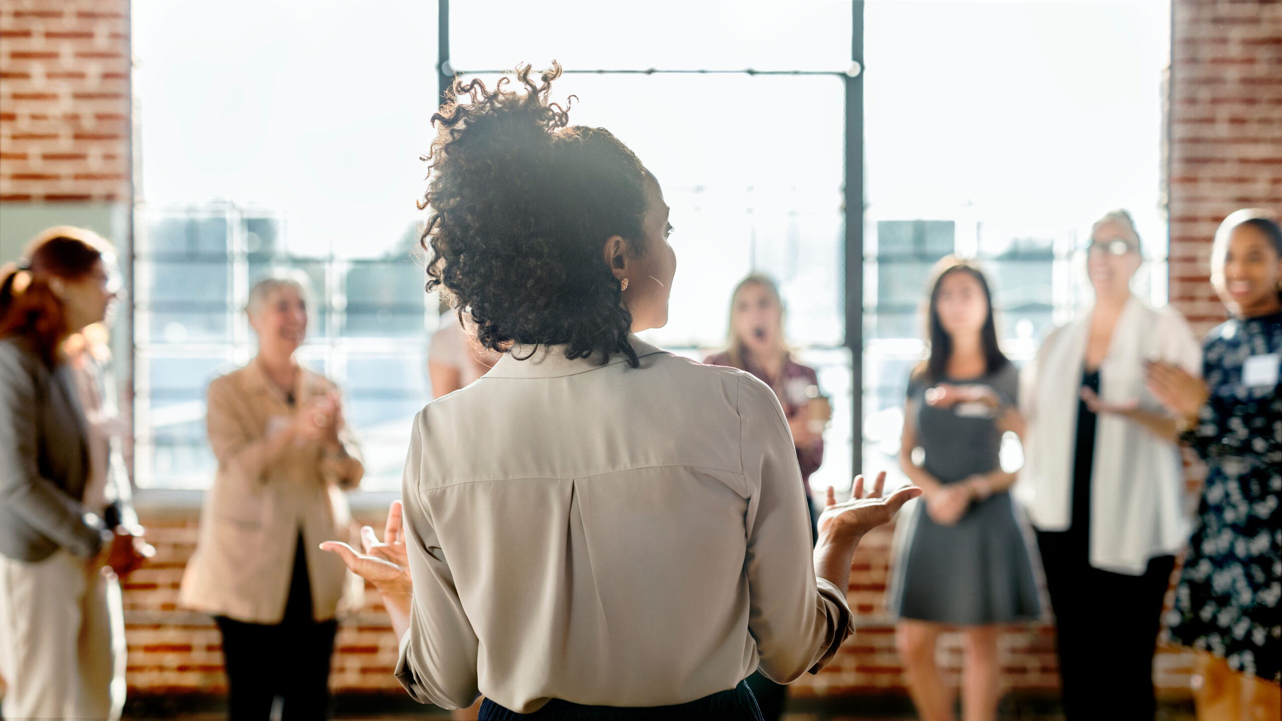 Young businesswoman talking to a crowd