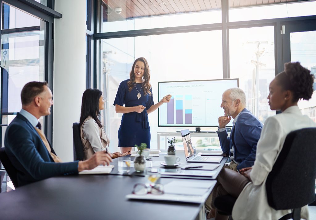 Businesswoman analysis giving a statistic presentation in a diverse boardroom