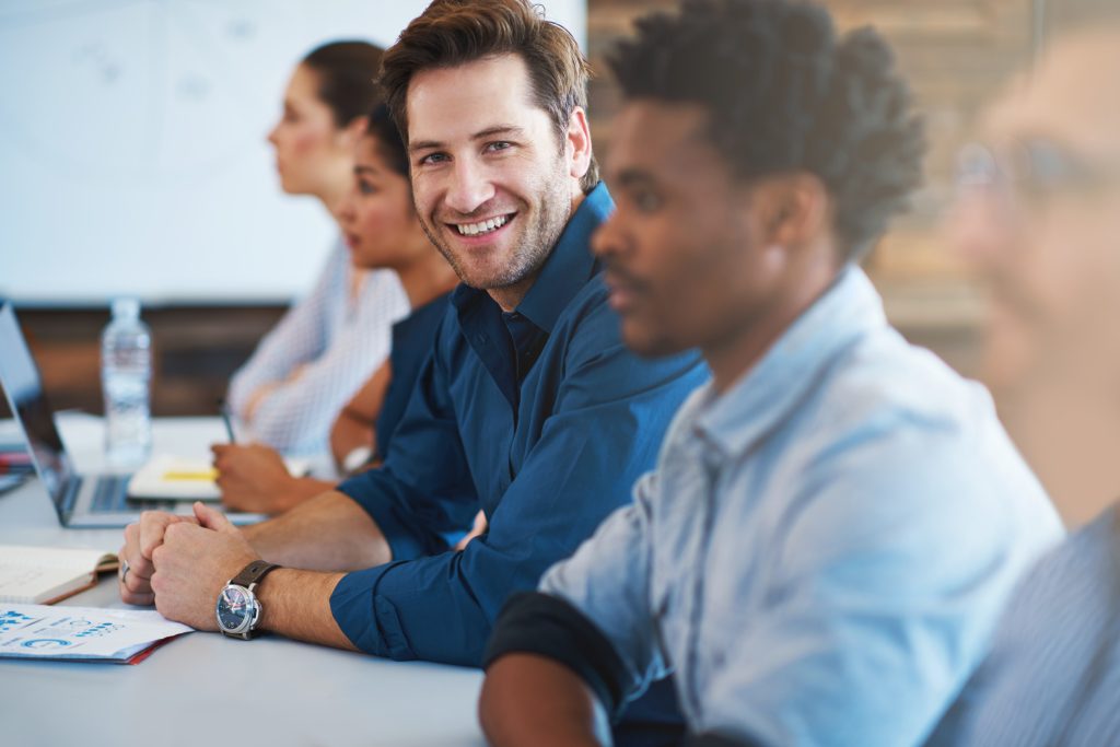 Portrait, happy and a business man in the boardroom with his team