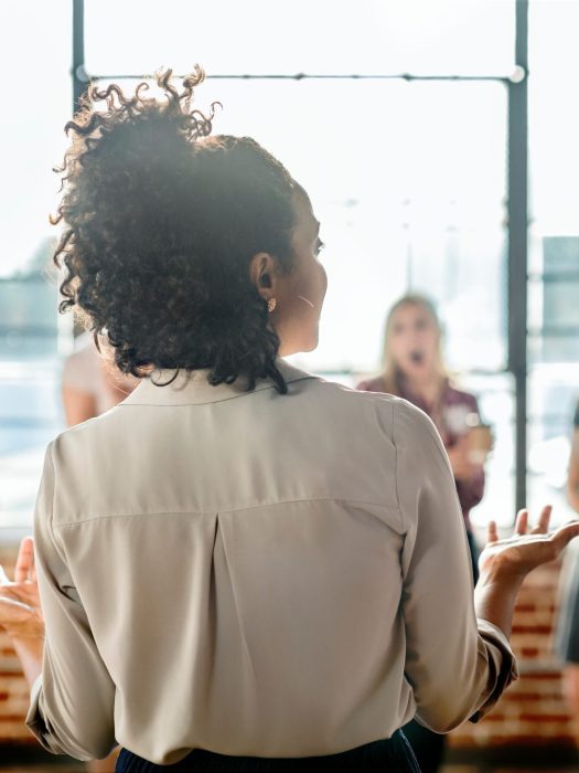 Young businesswoman talking to a crowd