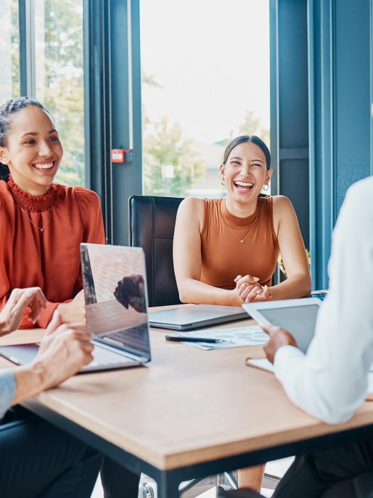 Laughing, planning business and women in a meeting