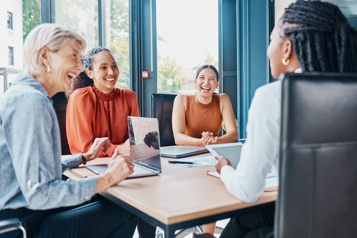 Laughing, planning business and women in a meeting for strategy, teamwork and a workforce team. Happy, office and diversity with people at work for a corporate collaboration and coworking together